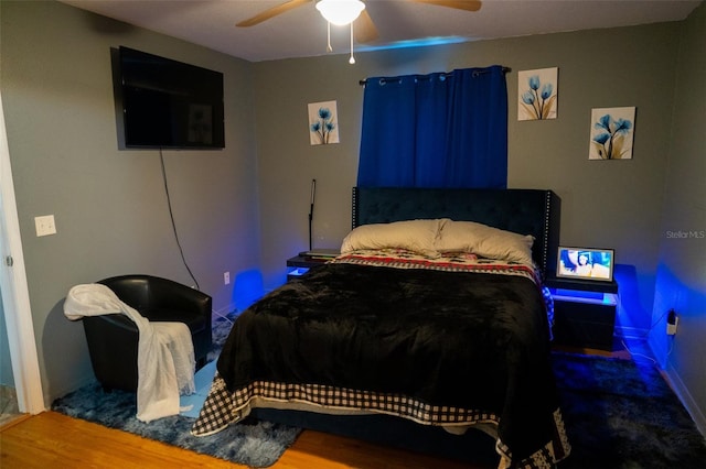 bedroom featuring wood-type flooring and ceiling fan