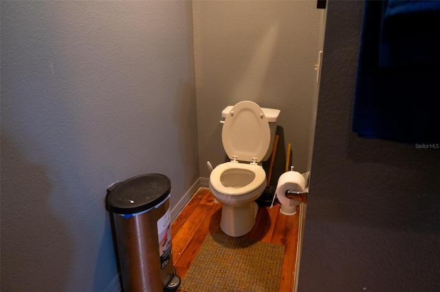 bathroom with toilet and hardwood / wood-style flooring