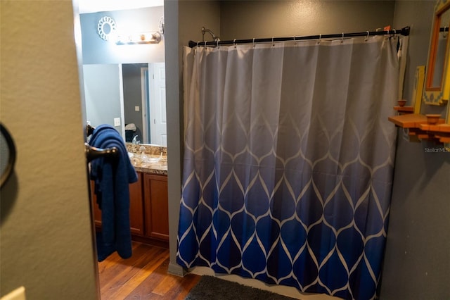 bathroom featuring a shower with shower curtain, vanity, and hardwood / wood-style flooring