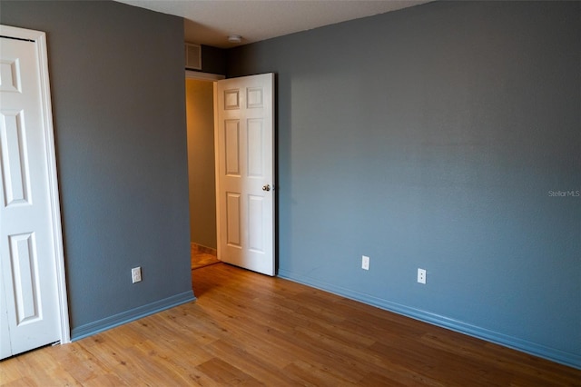 unfurnished bedroom featuring light wood-type flooring