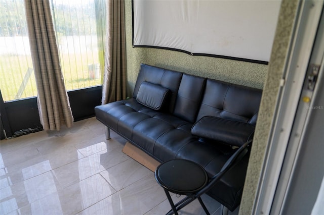 tiled living room with a healthy amount of sunlight