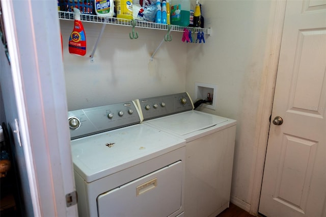 clothes washing area with washing machine and clothes dryer