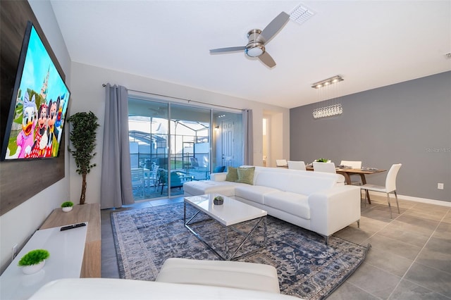 living room featuring tile patterned floors and ceiling fan