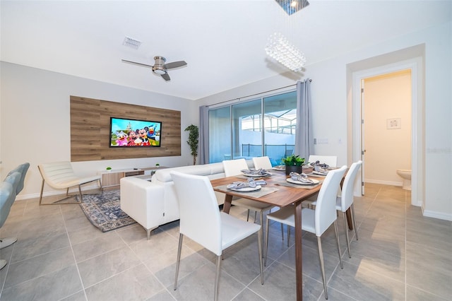 dining space with tile patterned flooring and ceiling fan