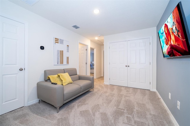 sitting room featuring light colored carpet