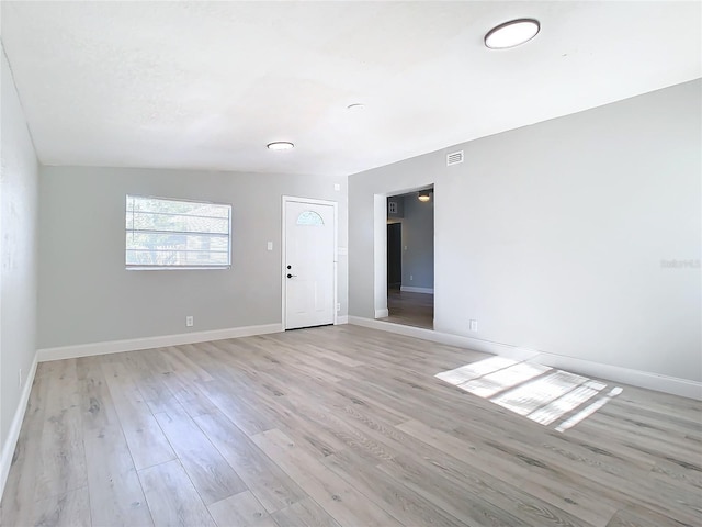 empty room with light hardwood / wood-style floors