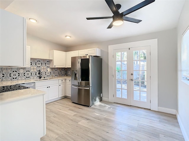 kitchen with white cabinets, light wood-type flooring, stainless steel refrigerator with ice dispenser, and french doors