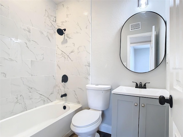 full bathroom featuring vanity, tiled shower / bath combo, and toilet