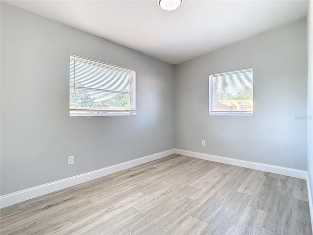 empty room featuring light hardwood / wood-style floors and a wealth of natural light