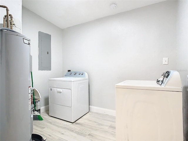 washroom with electric water heater, electric panel, light hardwood / wood-style floors, and washing machine and clothes dryer