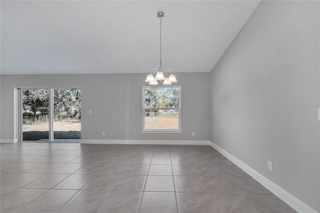 spare room with light tile patterned floors, an inviting chandelier, and lofted ceiling