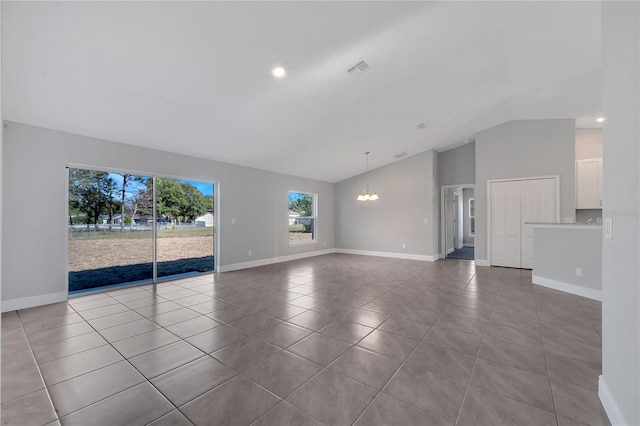 unfurnished living room featuring light tile patterned floors, vaulted ceiling, and a notable chandelier