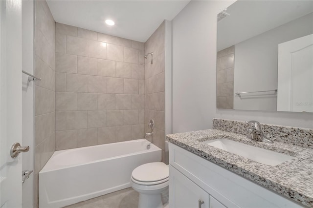 full bathroom with tile patterned flooring, vanity, tiled shower / bath combo, and toilet