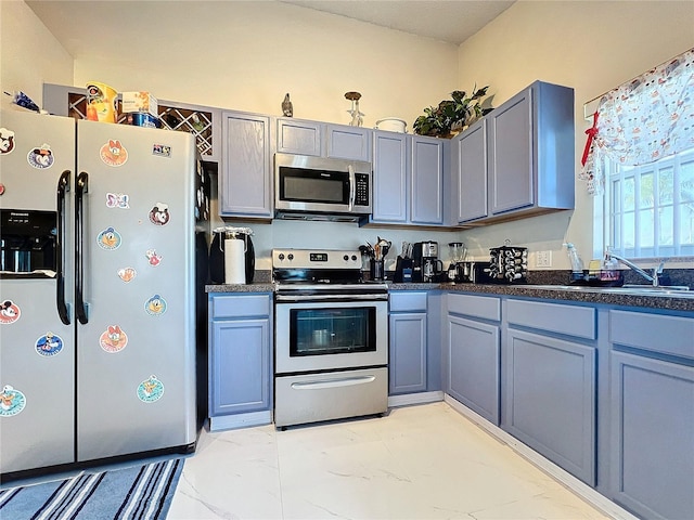 kitchen featuring gray cabinets and appliances with stainless steel finishes