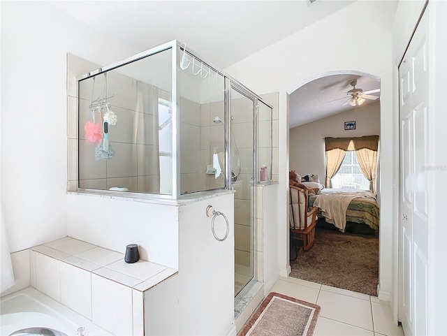 bathroom with tile patterned flooring, ceiling fan, a shower with shower door, and lofted ceiling