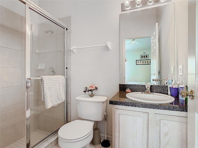 bathroom with vanity, toilet, and a shower with shower door