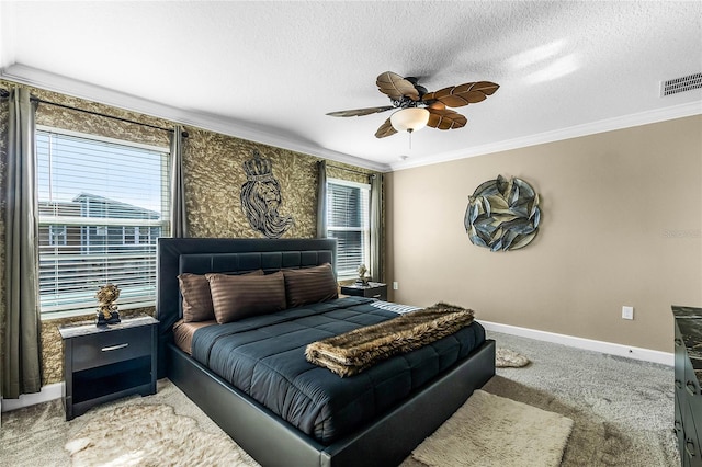 bedroom featuring ceiling fan, carpet floors, a textured ceiling, and ornamental molding