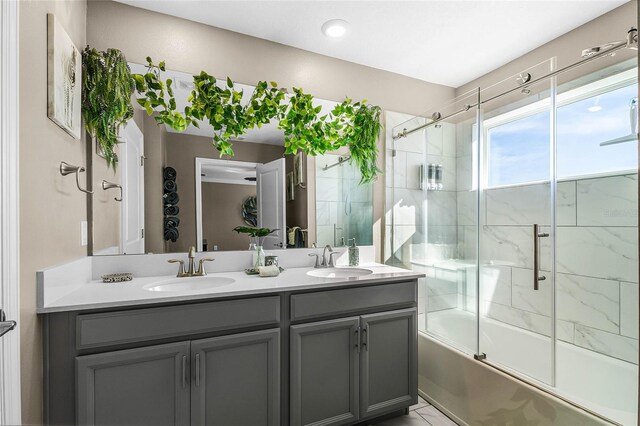 bathroom featuring vanity and shower / bath combination with glass door