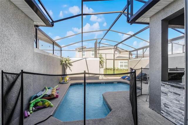 view of pool with a lanai and a patio area