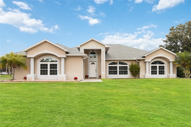 ranch-style home with a front lawn