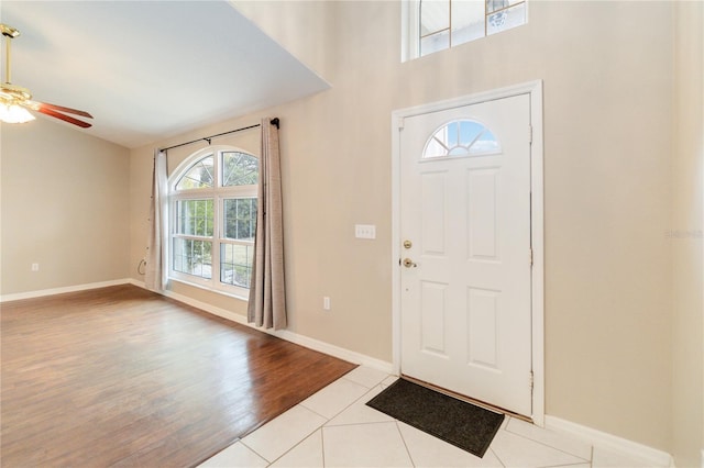 tiled entryway with ceiling fan