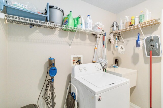 clothes washing area featuring washer / dryer