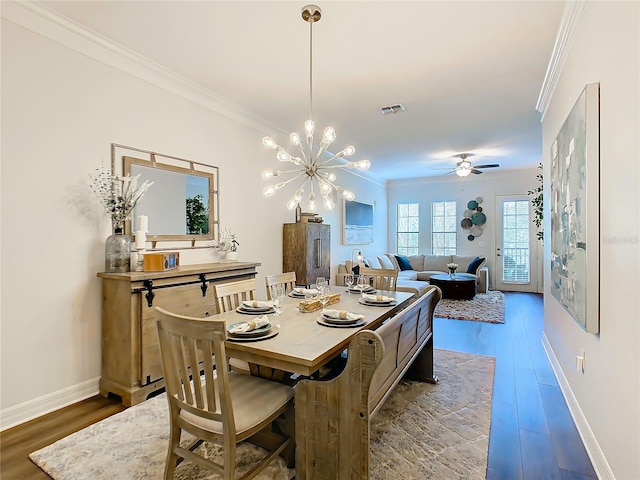 dining room with crown molding, hardwood / wood-style floors, and ceiling fan with notable chandelier