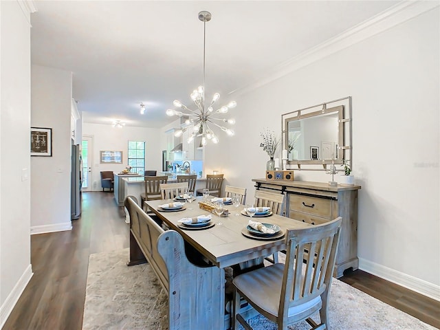 dining room with a chandelier, crown molding, and dark wood-type flooring