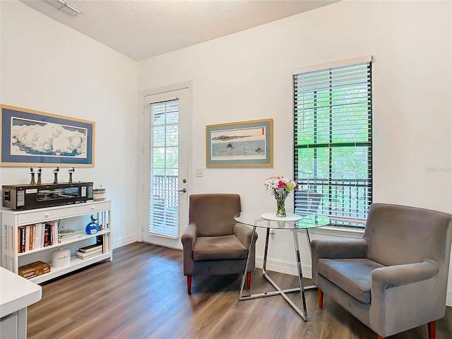 living area with a healthy amount of sunlight and hardwood / wood-style flooring