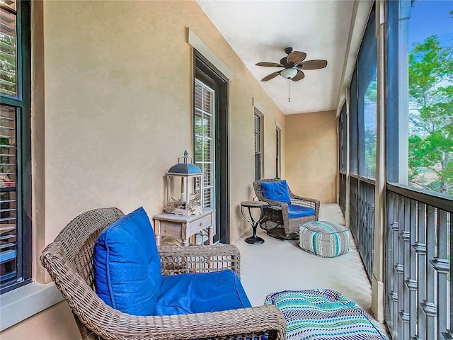 sunroom with a wealth of natural light and ceiling fan