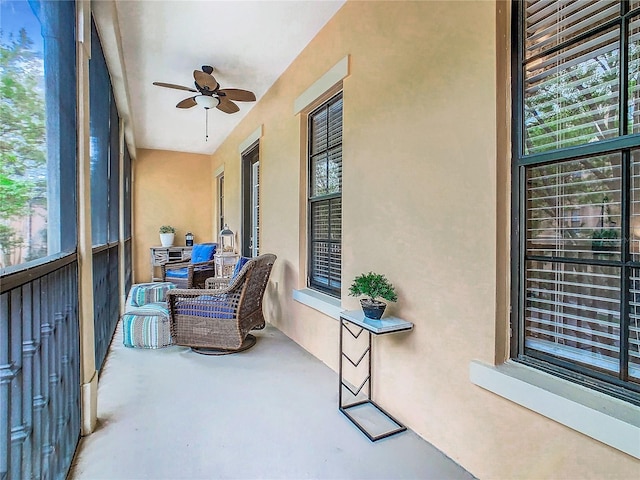 sunroom featuring ceiling fan and a healthy amount of sunlight