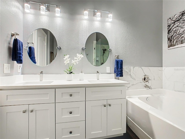 bathroom with vanity and a tub to relax in