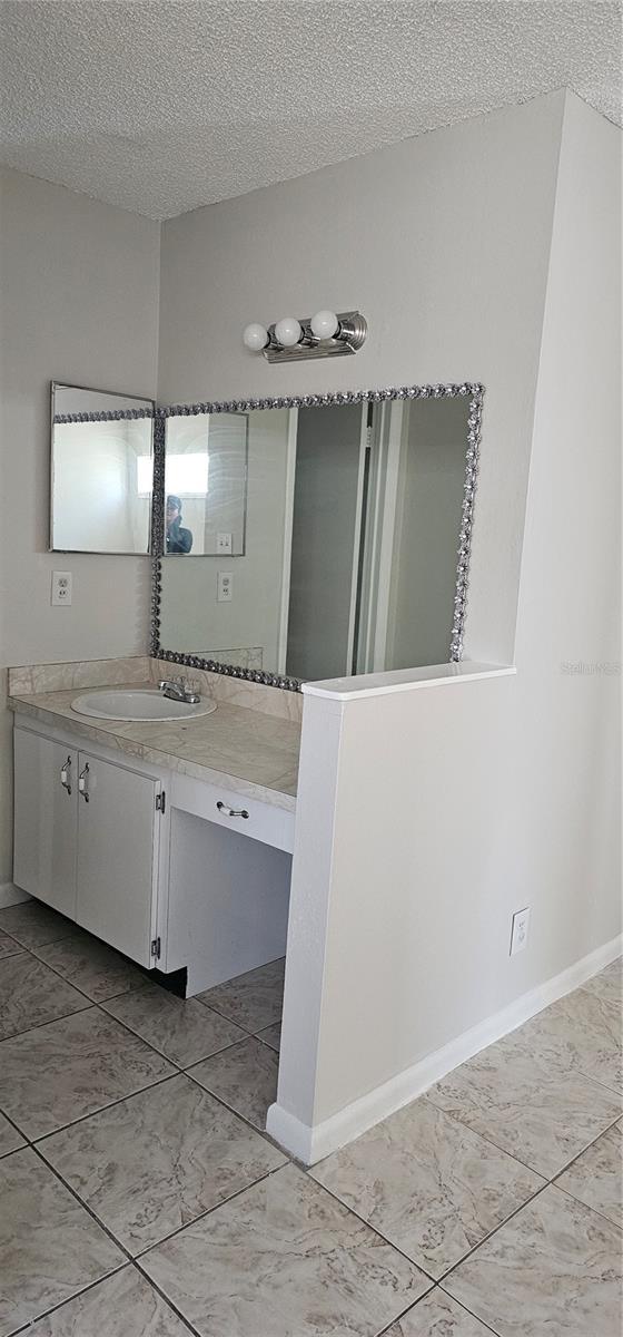 bathroom featuring vanity and a textured ceiling