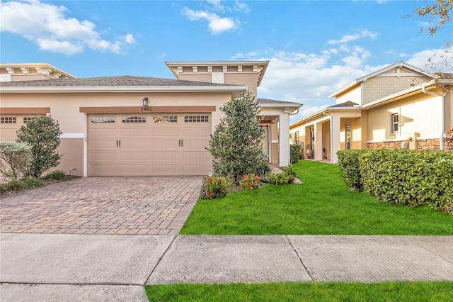 view of front of home with a garage and a front lawn