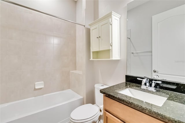 full bathroom with toilet, vanity, and tiled shower / bath