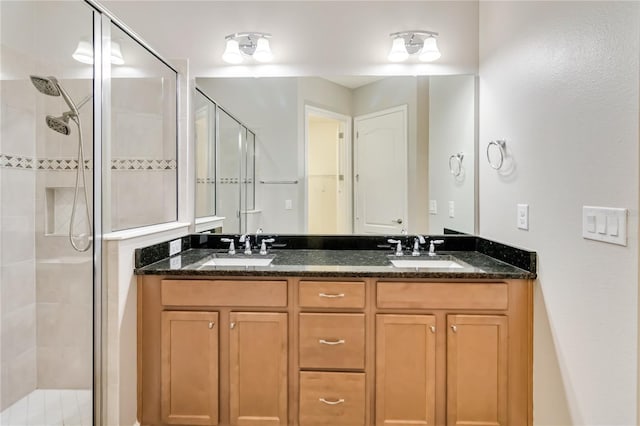 bathroom with vanity and a shower with door