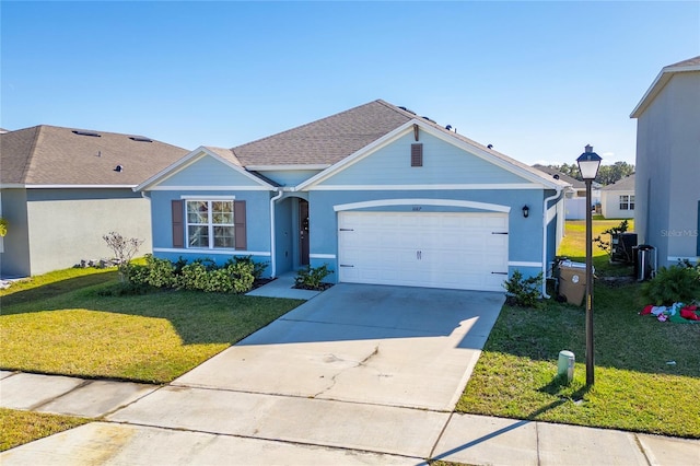 single story home with a garage and a front lawn