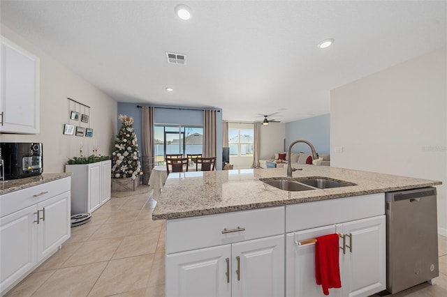 kitchen featuring stainless steel dishwasher, white cabinetry, sink, and a kitchen island with sink