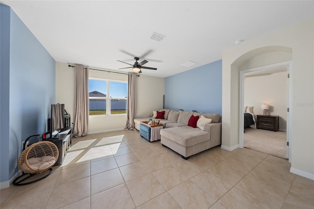 living room featuring ceiling fan and light tile patterned floors