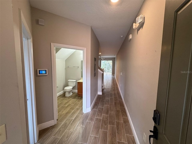 hallway with a textured ceiling