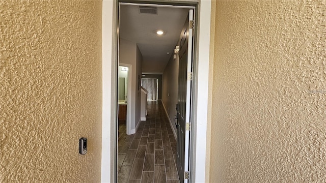 hallway with dark wood-type flooring