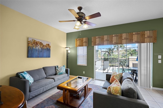 tiled living room with ceiling fan and a textured ceiling