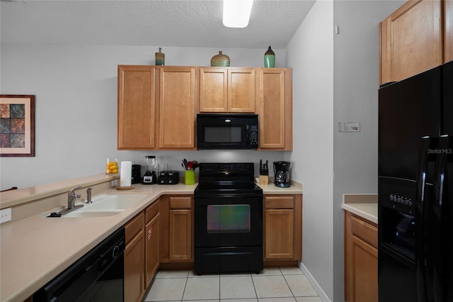 kitchen with light tile patterned flooring, a textured ceiling, sink, and black appliances