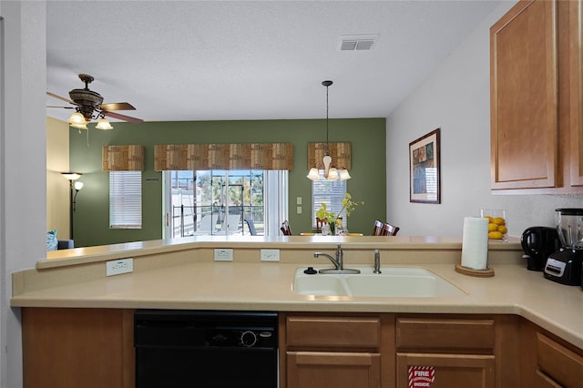 kitchen featuring ceiling fan with notable chandelier, sink, a textured ceiling, black dishwasher, and decorative light fixtures