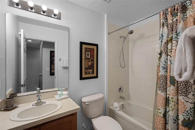 full bathroom featuring vanity, shower / bath combination with curtain, a textured ceiling, and toilet