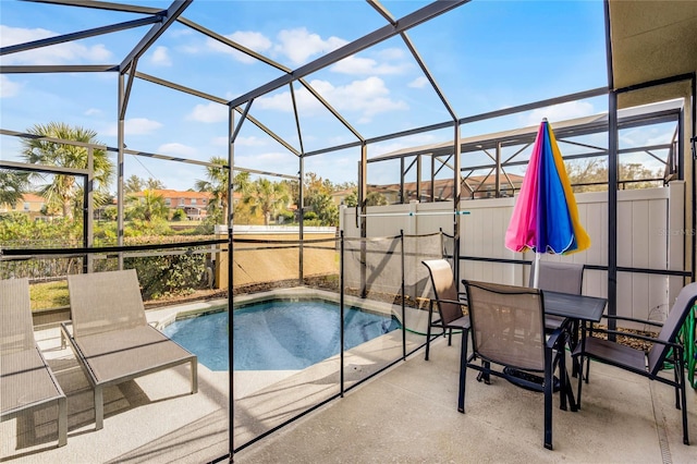 view of swimming pool featuring a lanai and a patio