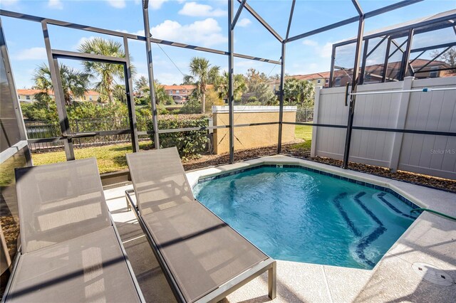 view of pool with a lanai and a patio area