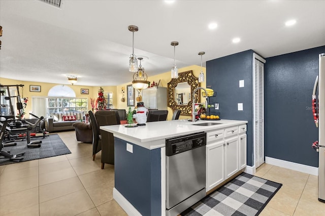 kitchen with pendant lighting, white cabinets, light tile patterned floors, and stainless steel appliances