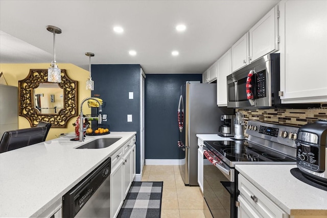 kitchen with white cabinets, pendant lighting, stainless steel appliances, and sink