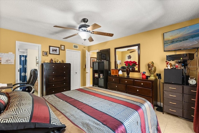 tiled bedroom featuring ceiling fan and a textured ceiling